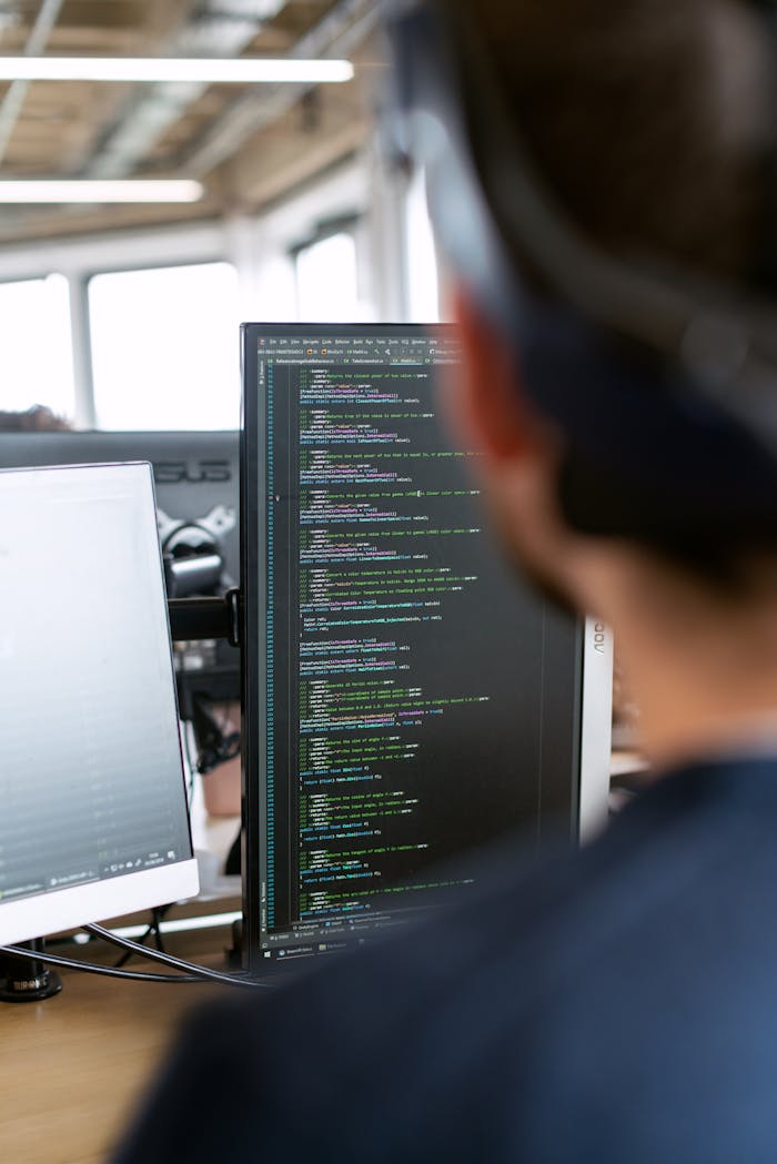 who-we-are A male software engineer working on code in a modern office setting.